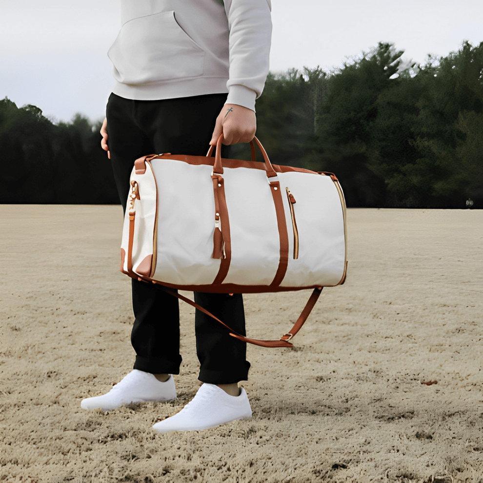 Person holding a stylish My Little Travel foldable travel bag in a natural outdoor setting.