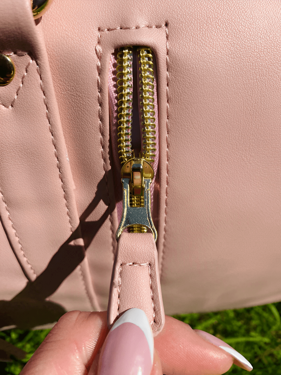 Close-up of a pink travel bag zipper showcasing its stylish design and quality craftsmanship.